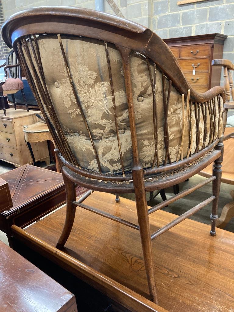 A late Victorian walnut caned seat back armchair